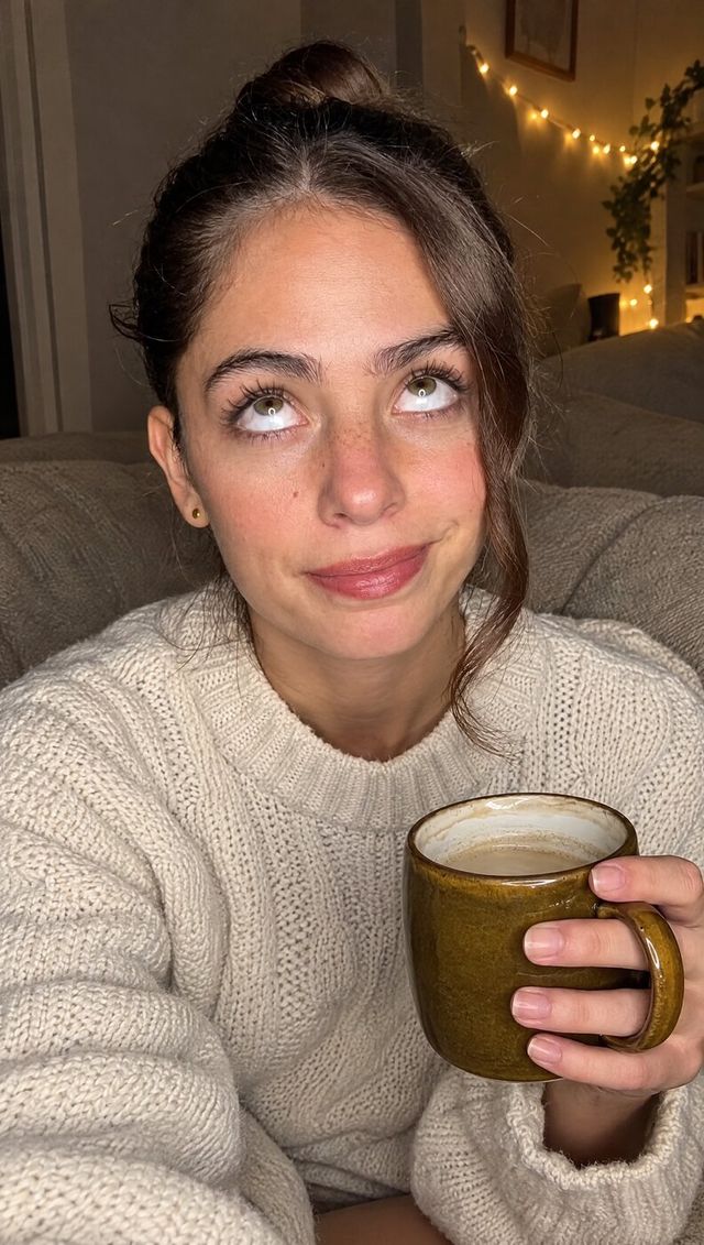 Nora rolling her eyes, mug in hand